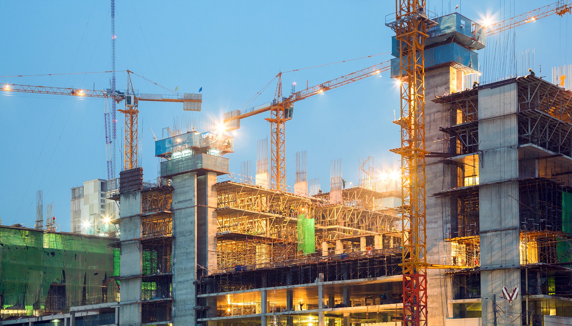 Construction site at dusk with tower crane